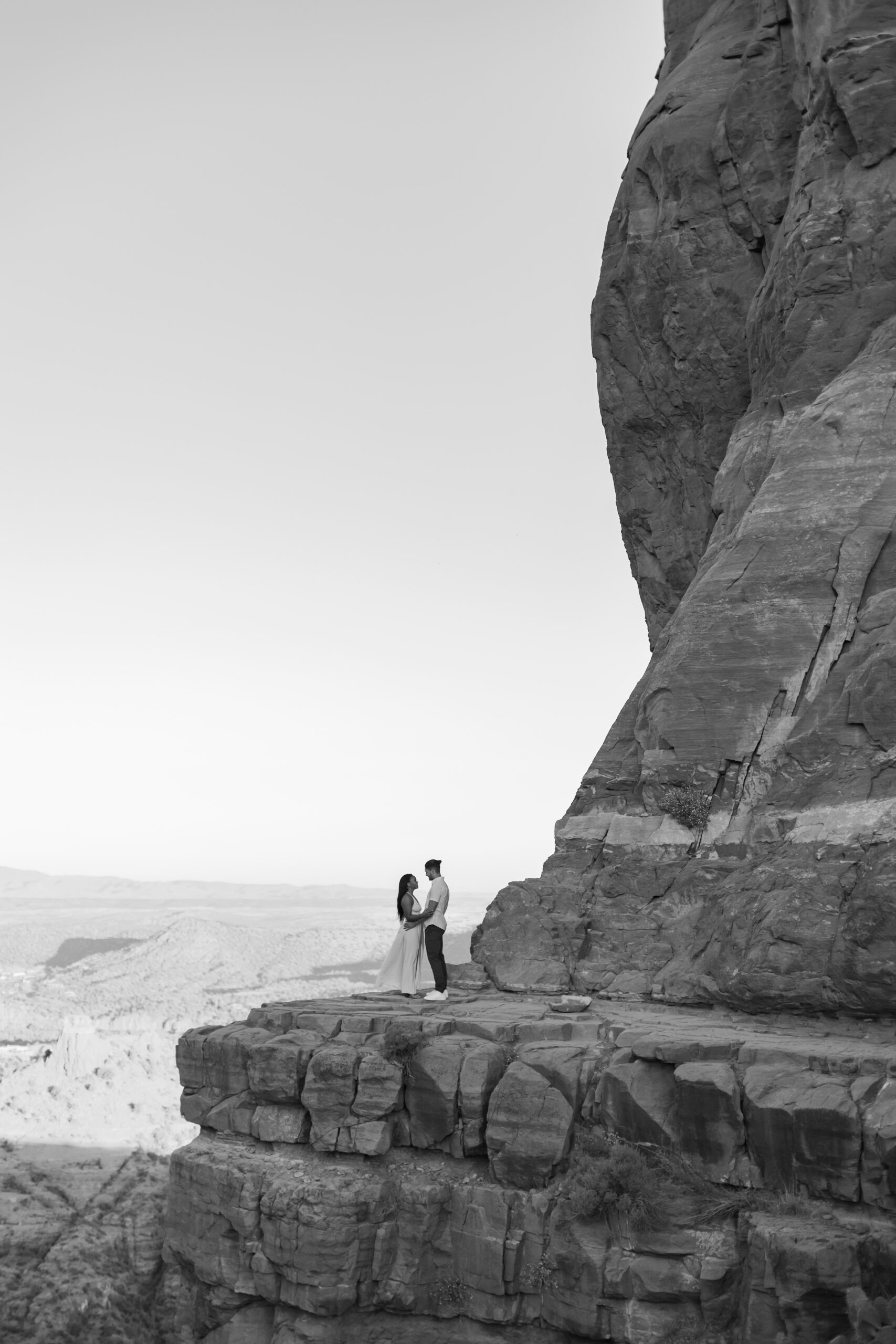 Photo of Lakin and Jasmyne at Sunrise:
"Lakin and Jasmyne stand together on top of Cathedral Rock in Sedona at sunrise, with the warm, golden light highlighting their joyful expressions and the stunning red rock formations in the background."