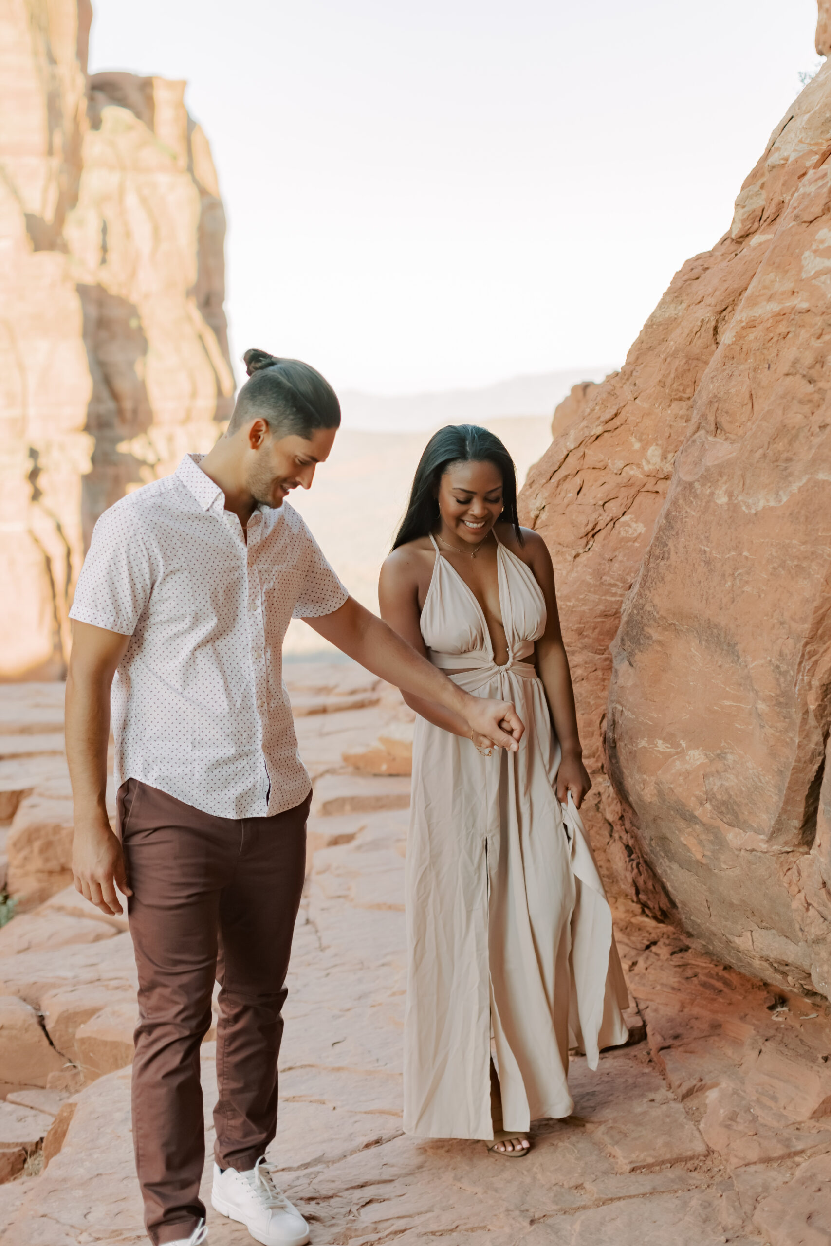 Photo of Lakin Helping Jasmyne Up the Rock:
"Lakin extends his hand to help Jasmyne climb up a rocky path on Cathedral Rock, showcasing their teamwork and love amidst the breathtaking Sedona landscape."