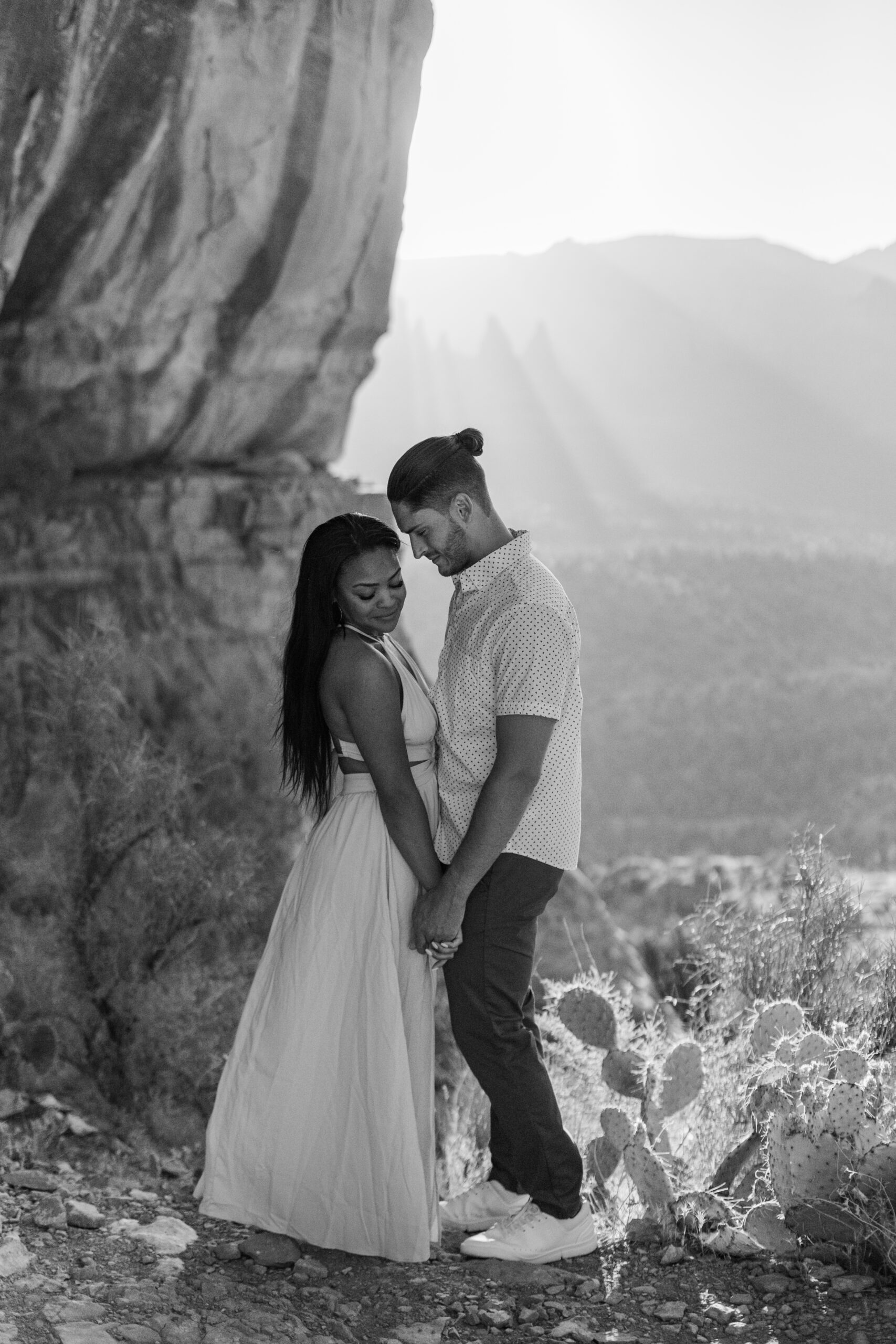 Photo of Lakin and Jasmyne at Sunrise:
"Lakin and Jasmyne stand together on top of Cathedral Rock in Sedona at sunrise, with the warm, golden light highlighting their joyful expressions and the stunning red rock formations in the background."