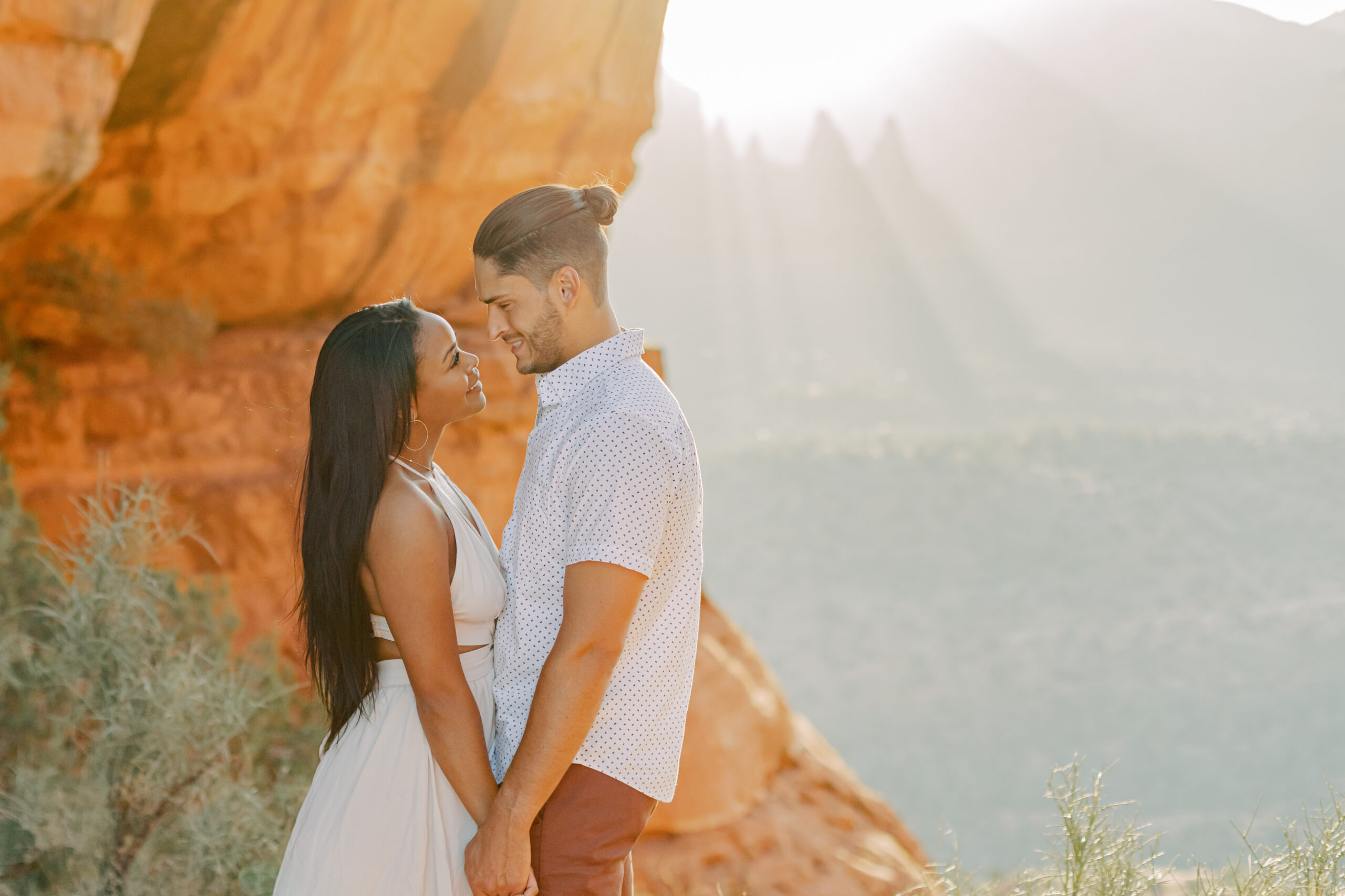 Photo of Lakin and Jasmyne with Outfit Change:
"Lakin and Jasmyne, dressed in stylish outfits after a quick change, pose confidently on top of Cathedral Rock, looking like models against the dramatic Sedona scenery."