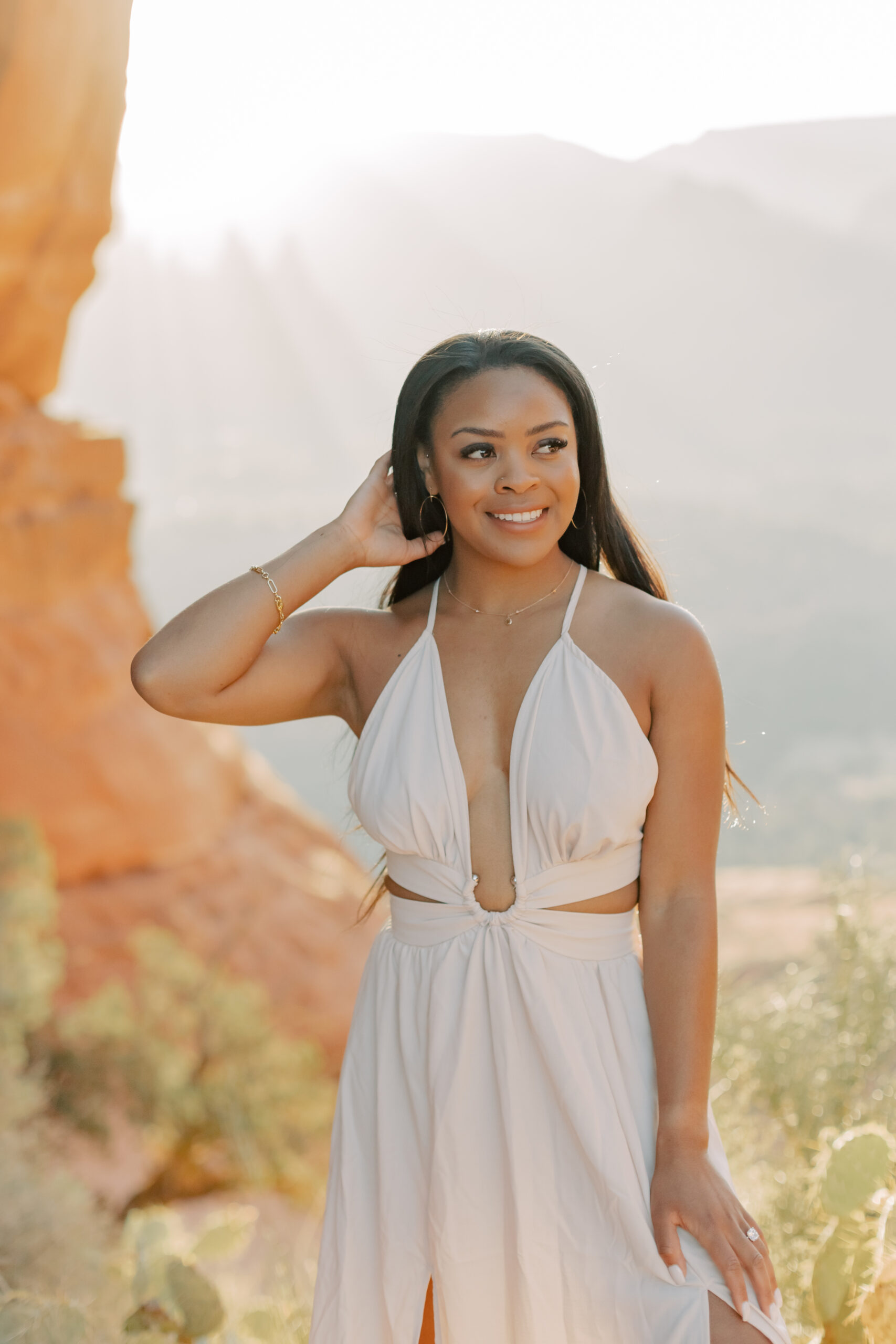 Photo of Lakin and Jasmyne at Sunrise:
"Lakin and Jasmyne stand together on top of Cathedral Rock in Sedona at sunrise, with the warm, golden light highlighting their joyful expressions and the stunning red rock formations in the background."