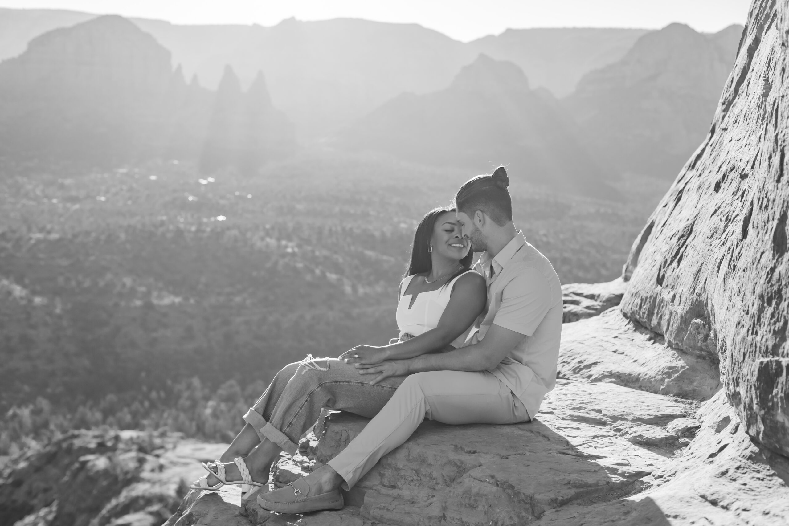 Photo of Lakin and Jasmyne at Sunrise:
"Lakin and Jasmyne stand together on top of Cathedral Rock in Sedona at sunrise, with the warm, golden light highlighting their joyful expressions and the stunning red rock formations in the background."