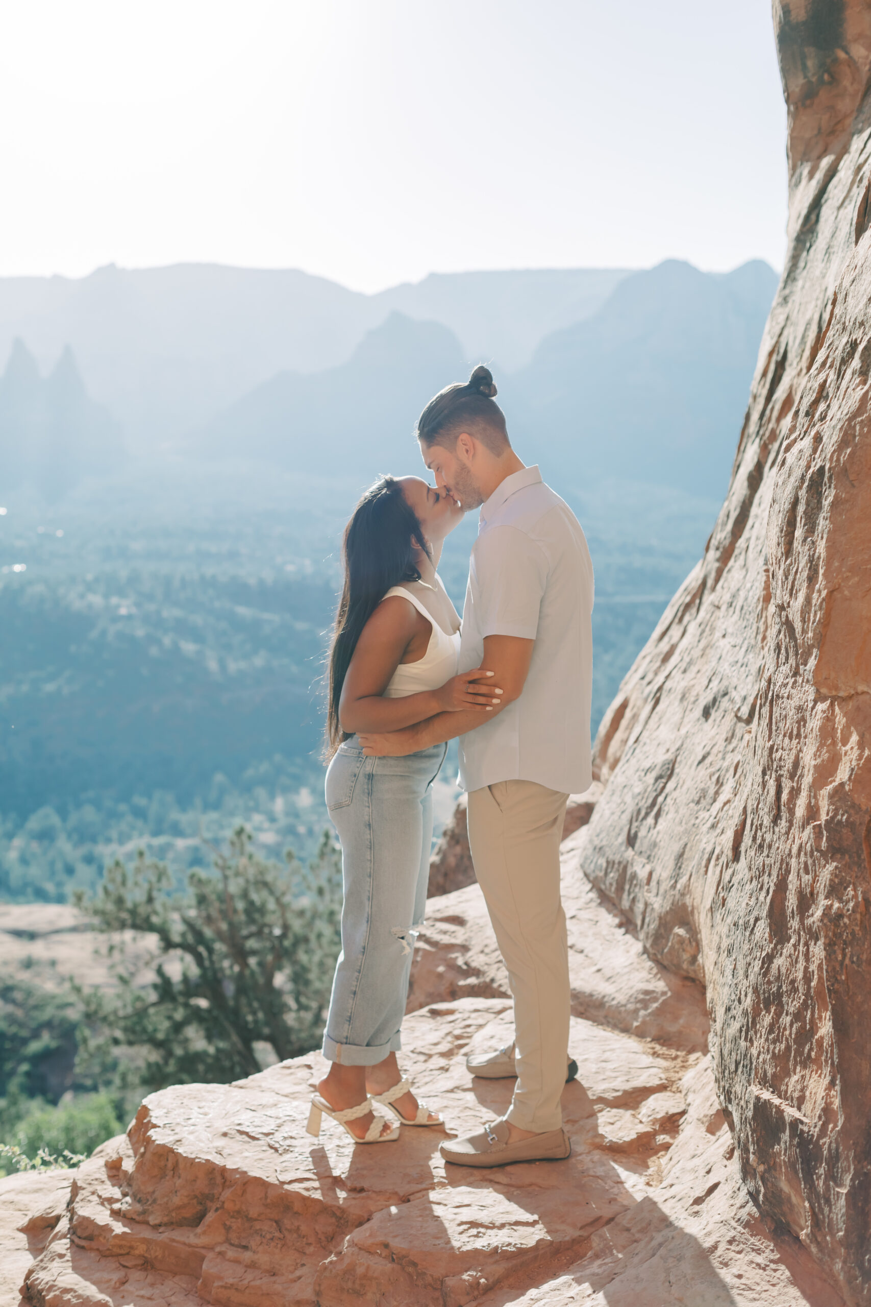 Photo of Lakin and Jasmyne at Sunrise:
"Lakin and Jasmyne stand together on top of Cathedral Rock in Sedona at sunrise, with the warm, golden light highlighting their joyful expressions and the stunning red rock formations in the background."