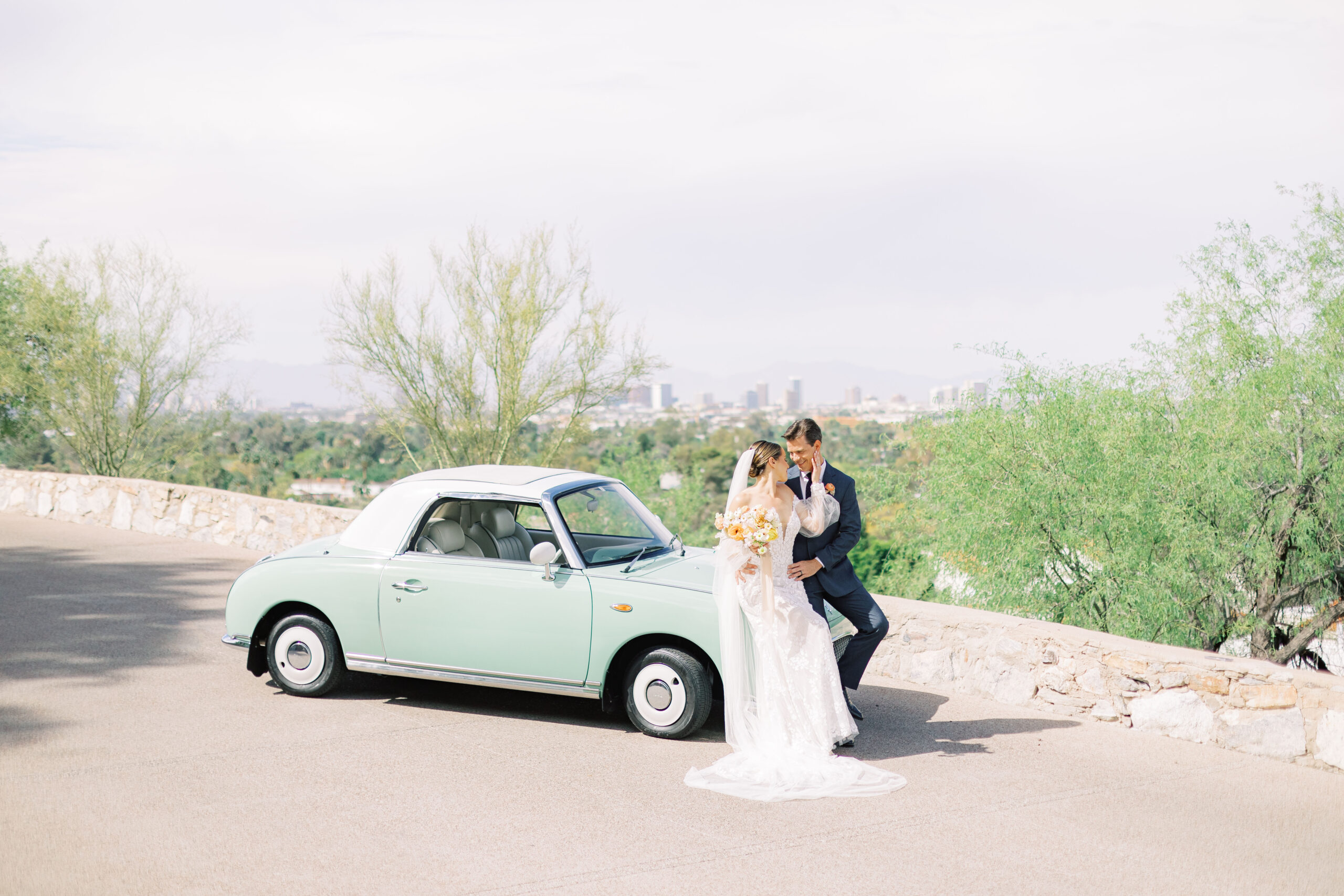 Bride and groom celebrating their wedding at Wrigley Mansion in Scottsdale, sharing a joyful moment with the historic mansion’s elegant architecture as their backdrop.