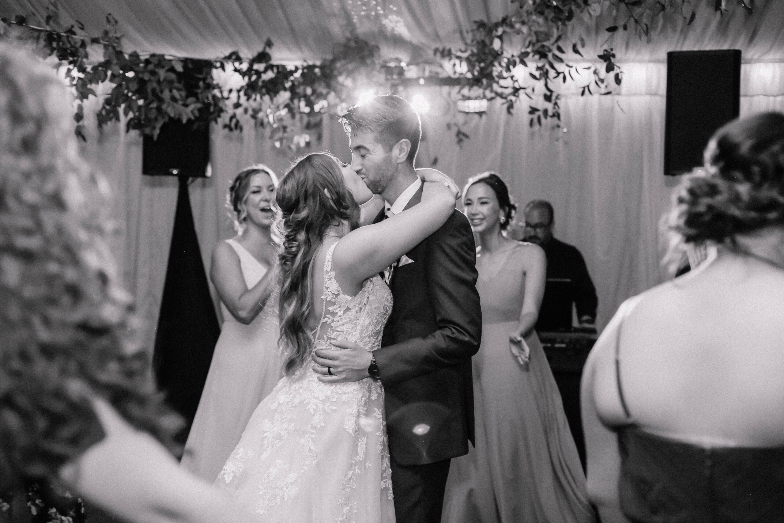 Bride and groom celebrating at their wedding reception at Stonebridge Manor, surrounded by lush gardens and elegant, timeless architecture.