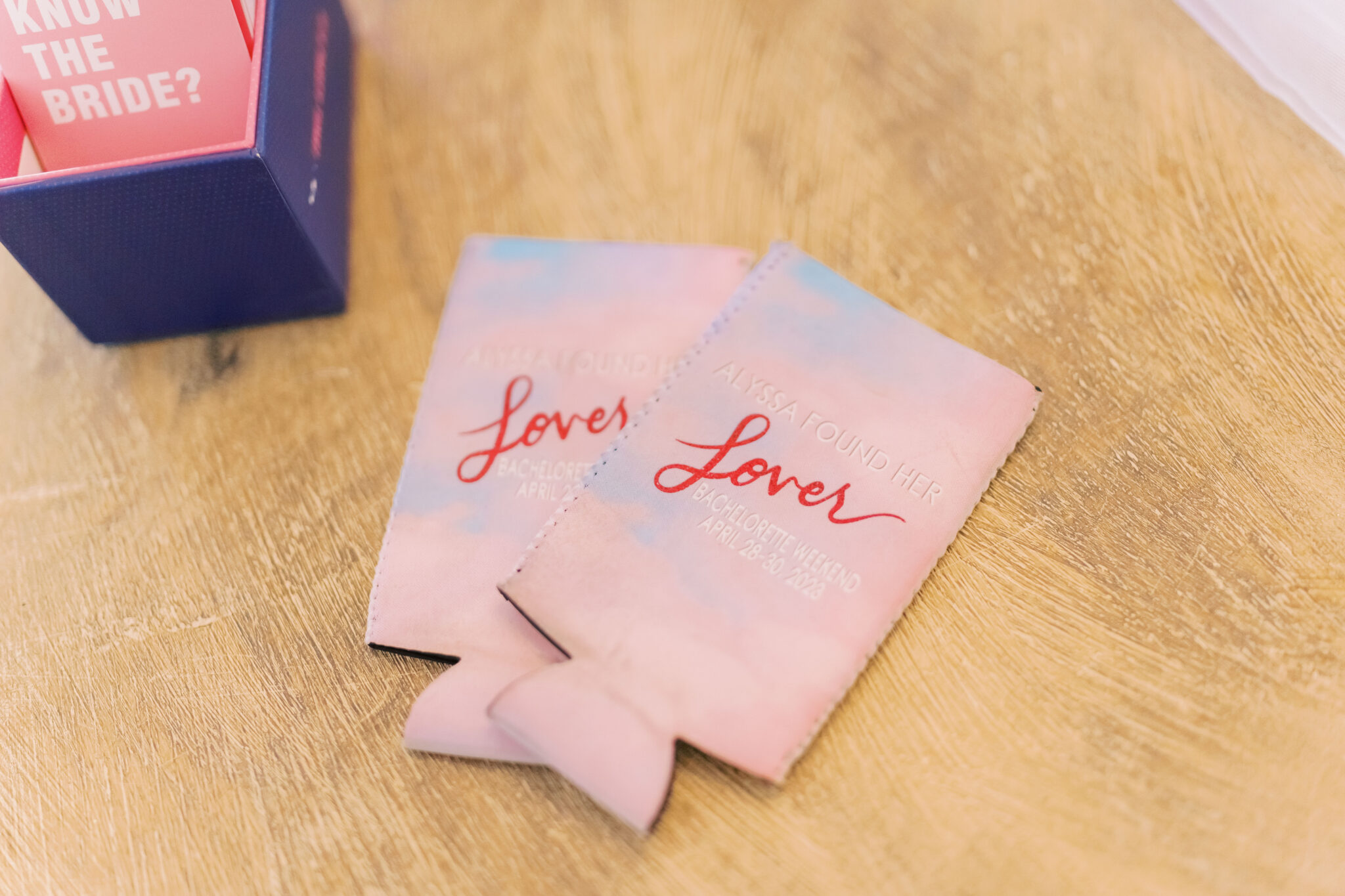 The bride had custom light pink koozies that read "Alyssa Found Her Lover"